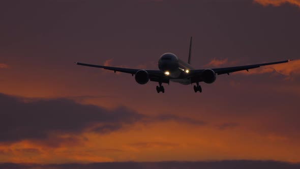 Airplane Approaching Over Ocean at Sunset Backgfround