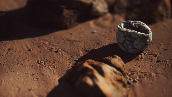 Old Football Ball on the Sand Beach alt