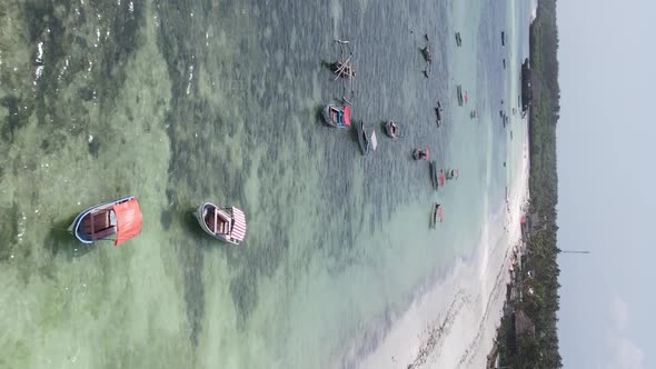 Vertical Video Boats in the Ocean Near the Coast of Zanzibar Tanzania Aerial View