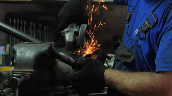 Craftsman Working With a Circular Saw, Sparks Fly From the Hot Metal