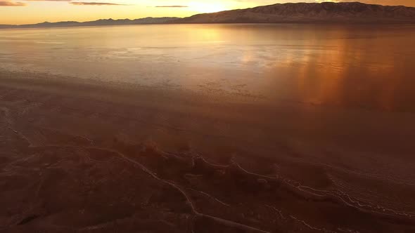 Aerial view of sunset reflection on frozen lake