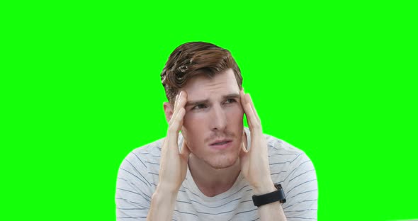 Worried Caucasian man on green background