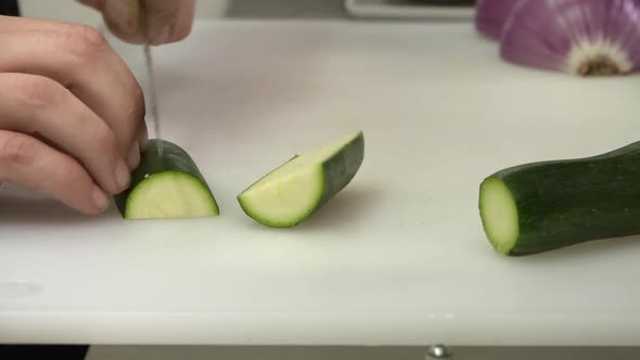 Chef slices zucchini perfectly. The shooting is raw, more reality cooking competition style. Great f
