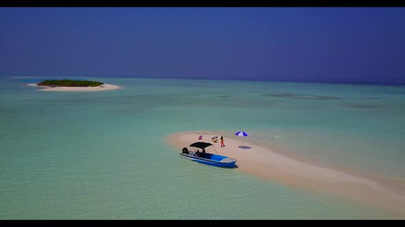 Aerial drone view seascape of tranquil island beach voyage by blue lagoon and white sand background 