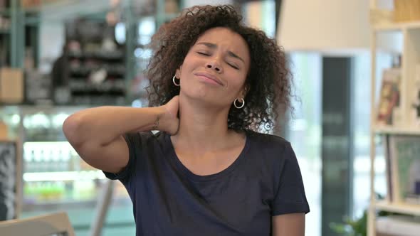 Portrait of Exhausted Young African Woman with Neck Pain