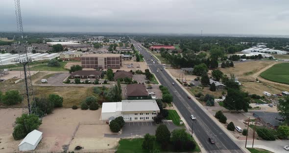 Drone follows road past Radio Towers in a suburban area.