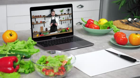 Laptop Computer with Man Chef Food Blogger in Screen Tells Teaches Students