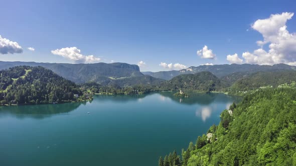 Lake Surrounded by Mountains, Small Island in Middle, Cloud Reflection in Water