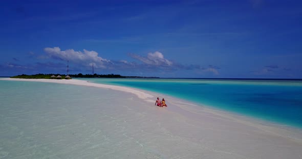 Beautiful people after marriage in love have fun on beach on white sand background