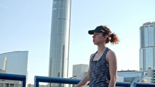 Female Athlete Drinking Water in Urban Setting