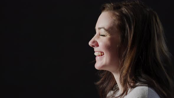 Side view of a woman laughing