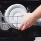 Female Hands Extract Basket of Dishwasher Takes Washed Plate From Open Machine - VideoHive Item for Sale