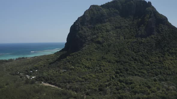 Aerial view of a person doing paragliding among the mountain, Mauritius.