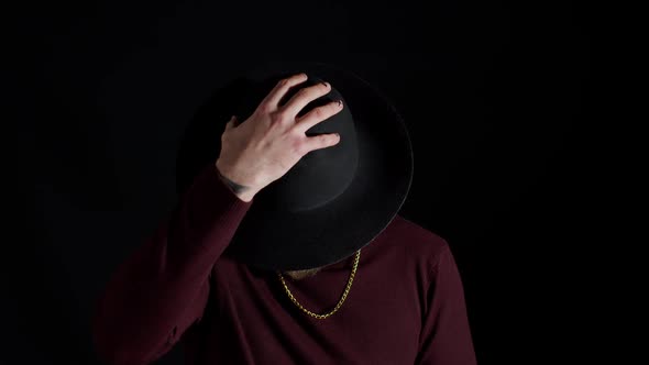 Portrait of Seductive Smiling Young Man in Trendy Stylish Clothes Wearing Hat on Black Background