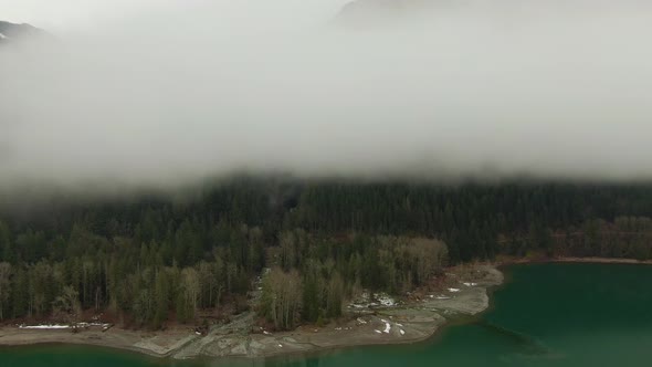 Aerial View of Canadian Mountain Landscape Covered in Fog Over Harrison Lake