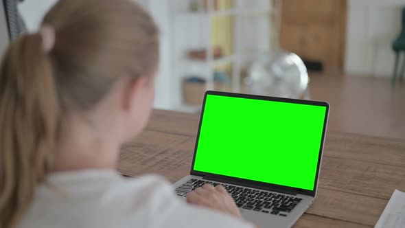Woman Using Laptop with Green Chroma Screen