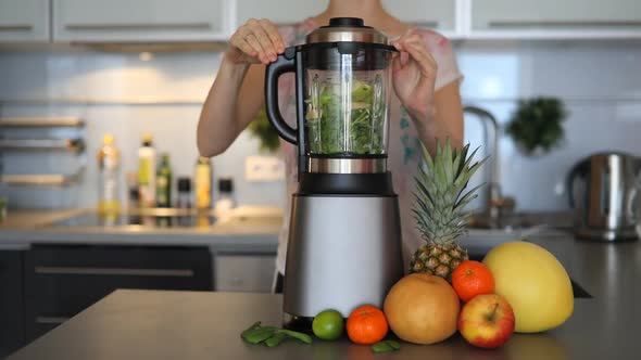 Woman Making Green Smoothies with Blender in Home Kitchen, Healthy Eating Lifestyle Concept