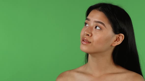 Beautiful Asian Woman Looking Away Dreamily on Chromakey Background