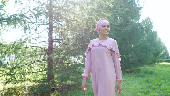 Young Muslim Woman in Turban and Closed Dress in the Park