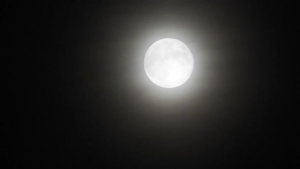 Moon with clouds at night. Spooky scene with full moon and clouds on a dark night alt