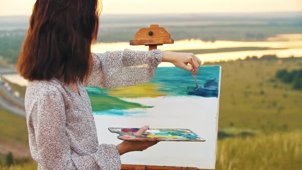 Young Woman Drawing a Painting on Nature  Drawing Blue Sky