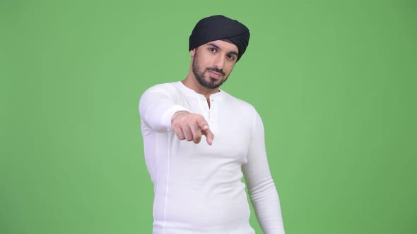 Young Handsome Bearded Indian Man Pointing To Camera
