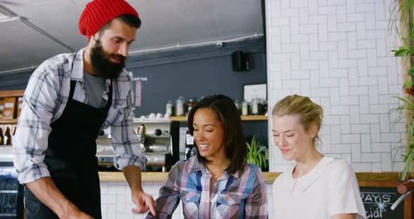 Waiter serving coffee to customer