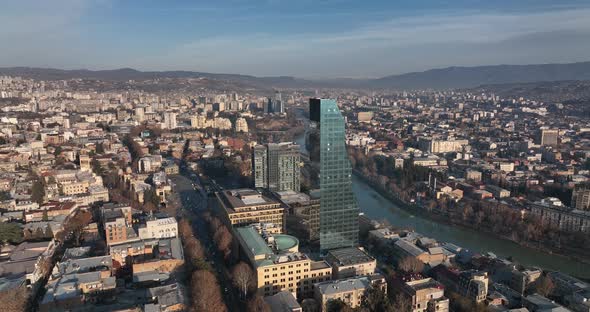 Flying over Shota Rustaveli street in the center of city. Morning aerial cityscape of Tbilisi