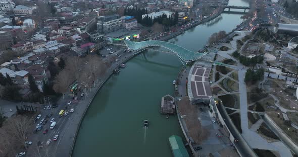 Aerial view of Tbilisi city central park and Bridge of Peace. Beautiful cityscape of old Tbilisi