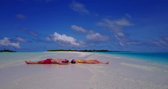 Romantic boy and girl after marriage in love enjoy luxury on beach on clean white sand background 