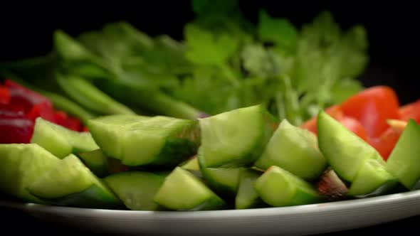 pour olive oil on Italian salad with mini mozzarella, tomatoes cherry and arugula rotating