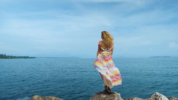 Girl in a Beautiful Dress Is Standing on the Coast