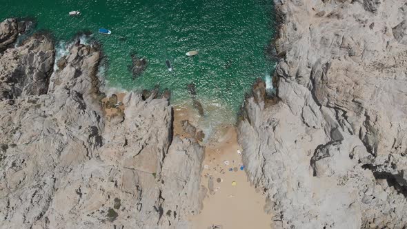 Aerial View of Beach Between Rock Formations
