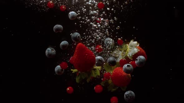 Falling Berries Into Water on a Black Background