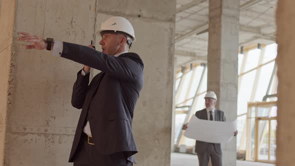 Businessman Using Walkie-Talkie at Construction Site