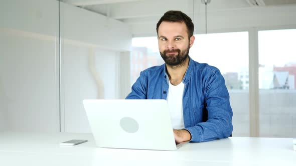 Designer Shaking Head in Denial Rejecting Man at Work