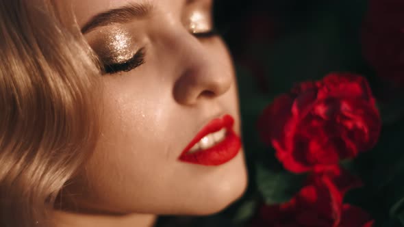 Fabulous Girl with Red Lips in Red Dress on Awesome Summer Roses Background