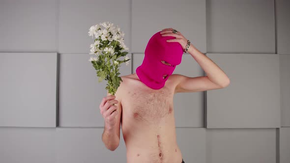 Anonymous Shirtless Man in Balaclava with Flowers