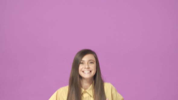 Slowmotion Optimistic and Supportive Adorable Caucasian Woman in Yellow Shirt Jumping From Bottom