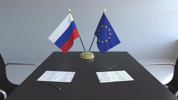 Flags of Russia and the European Union on the Table