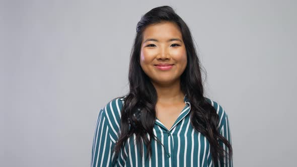 Happy Asian Woman Over Grey Background