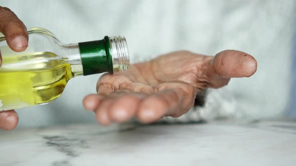 Senior Women Hand Holding Almond Oil with Copy Space