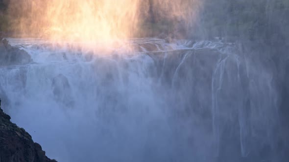 Zoomed view of Shoshone Falls as mist rises and birds fly