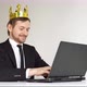 Self-confident arrogant businessman with golden crown on head using laptop. - VideoHive Item for Sale