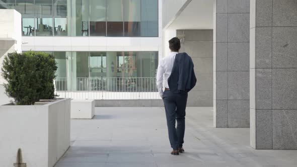 Relaxed Businessman Walking Outdoors During Work Break