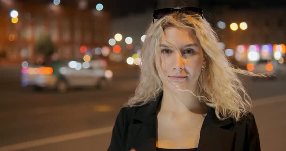 Wind Blows Nice Lady Curly Hair Against Bright City Lights