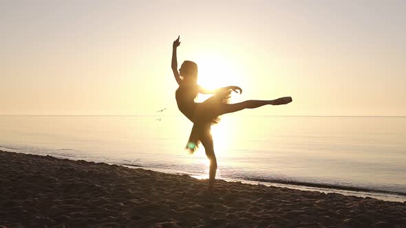 Silhouette of an Elegant Ballerina in a Tutu in the Rays of the Morning Sun