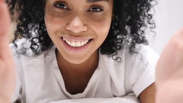 AfroAmerican Woman Taking Selfie in Bed Front Camera View