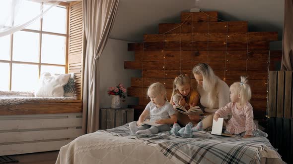 Woman Reading Book for Three Kids Girl Inside Cozy Room