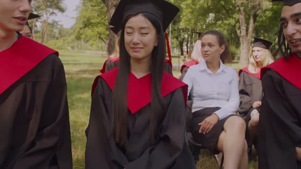 Caring Mom Encouraging Worried Female Graduate at Graduation Ceremony